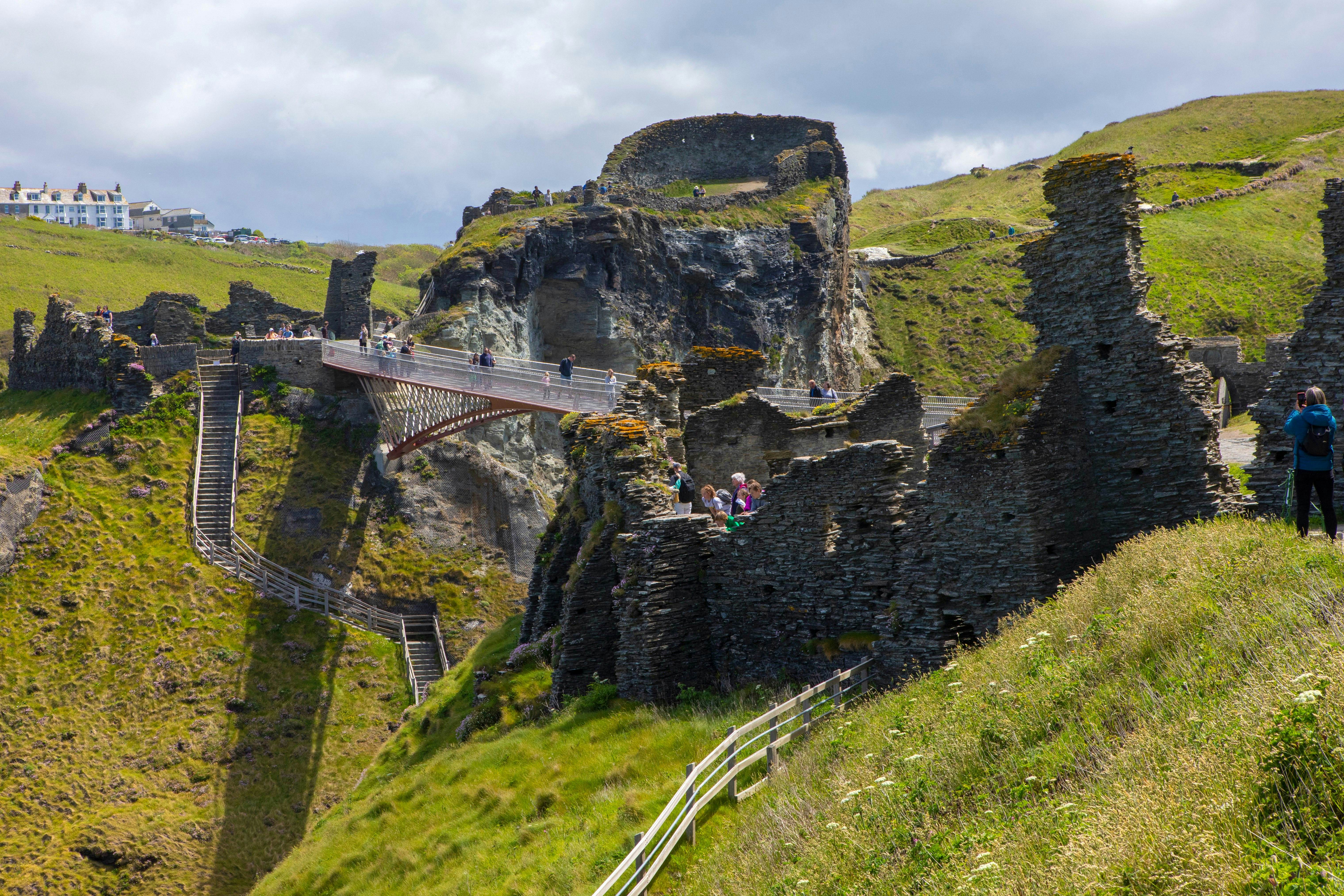 A view of the footbridge and castle ruins at Tintagel Castle in Cornwall, UK.; Shutterstock ID 1988916434; your: Bridget Brown; gl: 65050; netsuite: Online Editorial; full: POI Image Update